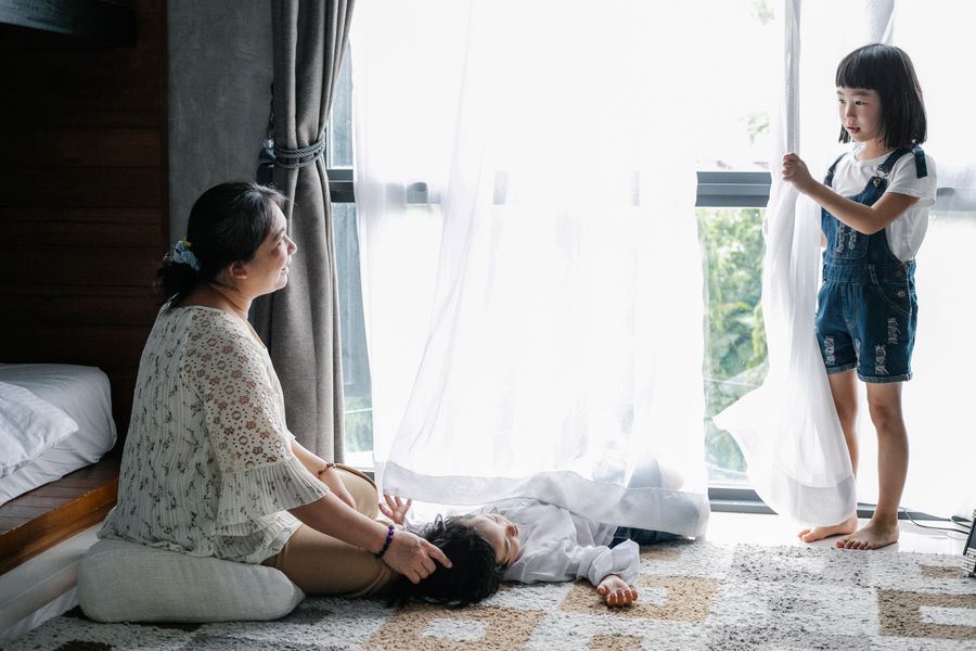A grandmother spending time with her grandchildren, representing multigenerational legacy