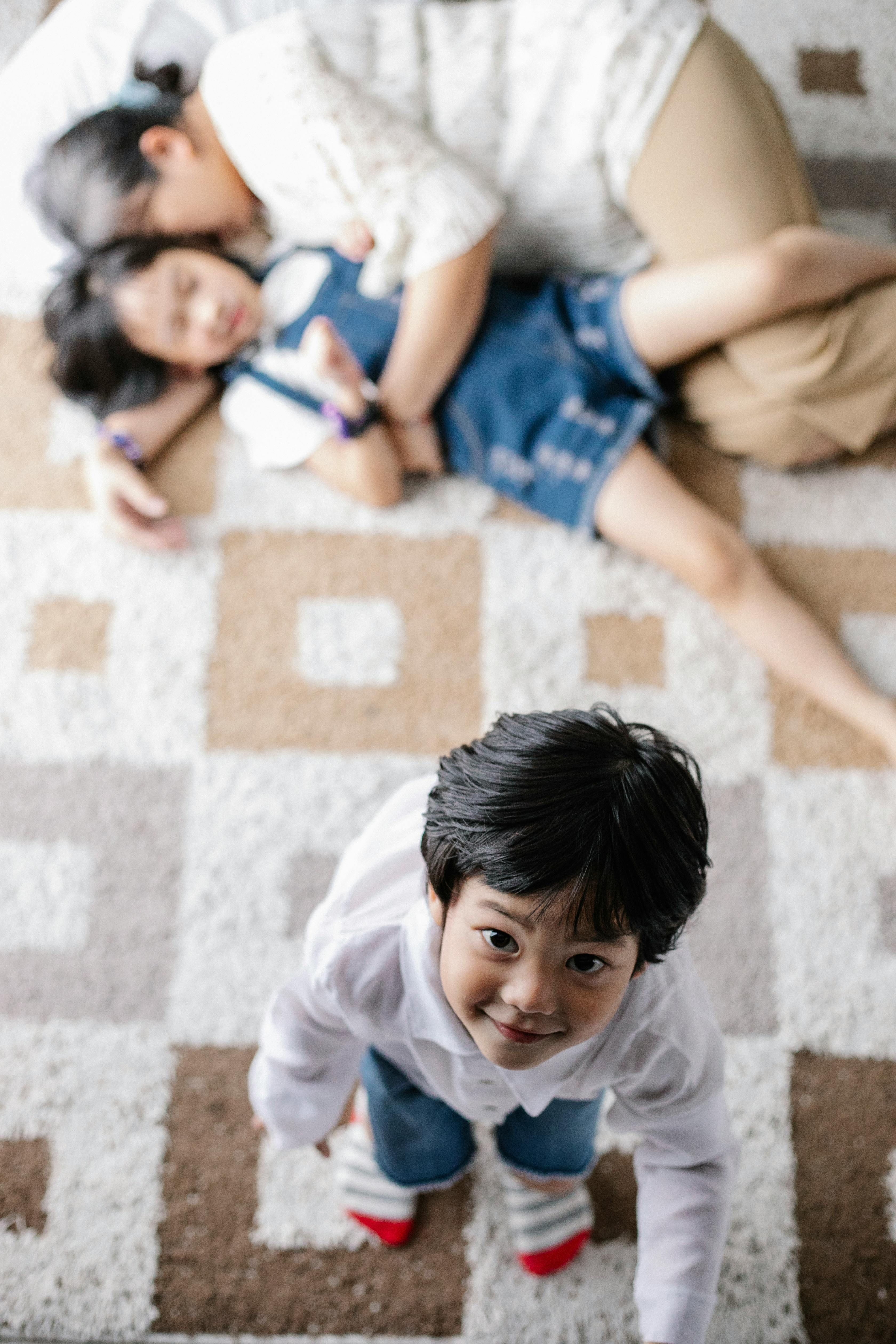 happy asian boy playing with relatives