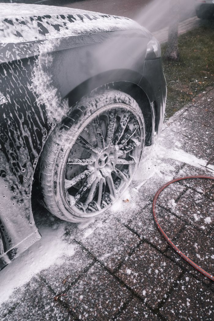 Wheel being washed with foam