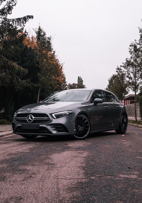 Free A stylish Mercedes-Benz car parked on an autumn street, showcasing modern automotive design. Stock Photo