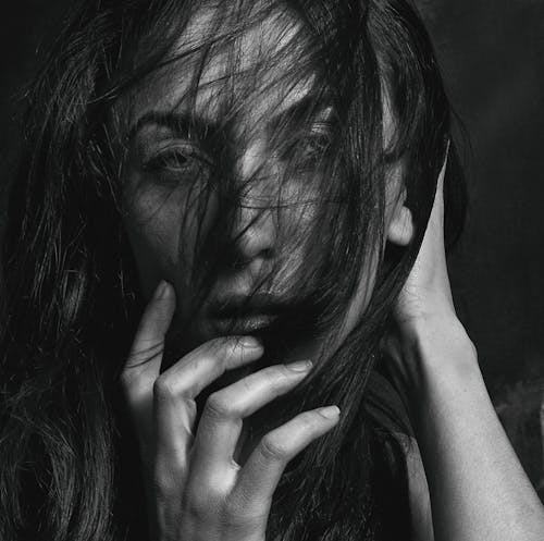 Grayscale Photo of Woman's Hair Covering Her Face