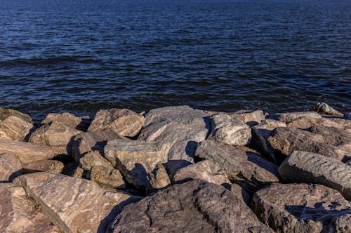 Free Gray and Brown Rocks Beside Body of Water Stock Photo