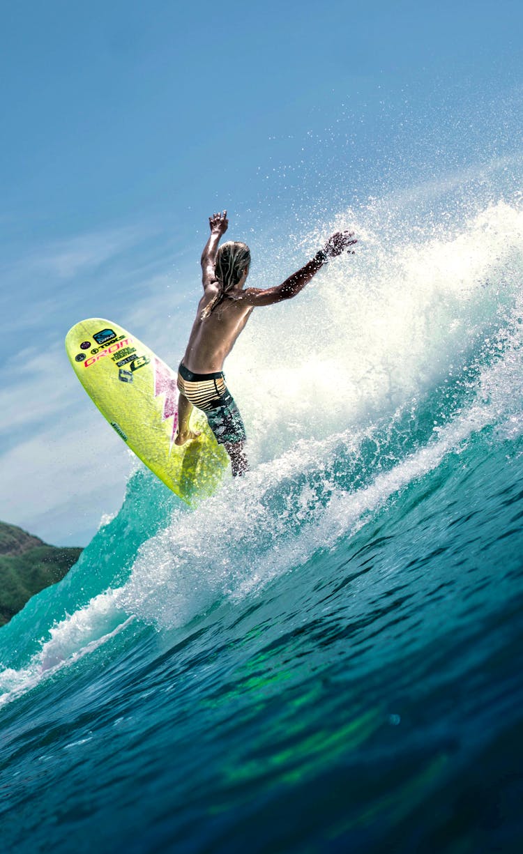 Anonymous Male Surfer Riding Wave In Sea