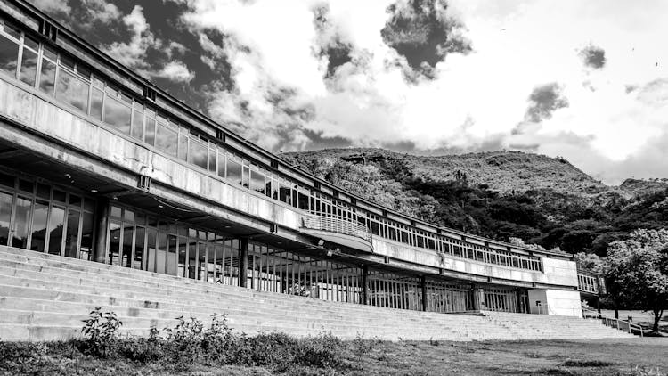 Low Rise Construction By Mountain Under Sky