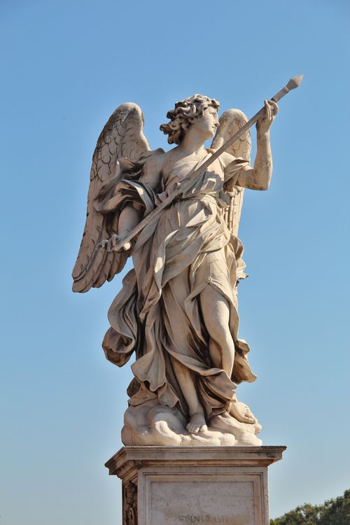 Free Stunning marble angel statue with spear under a bright blue sky, ideal for architectural and artistic themes. Stock Photo