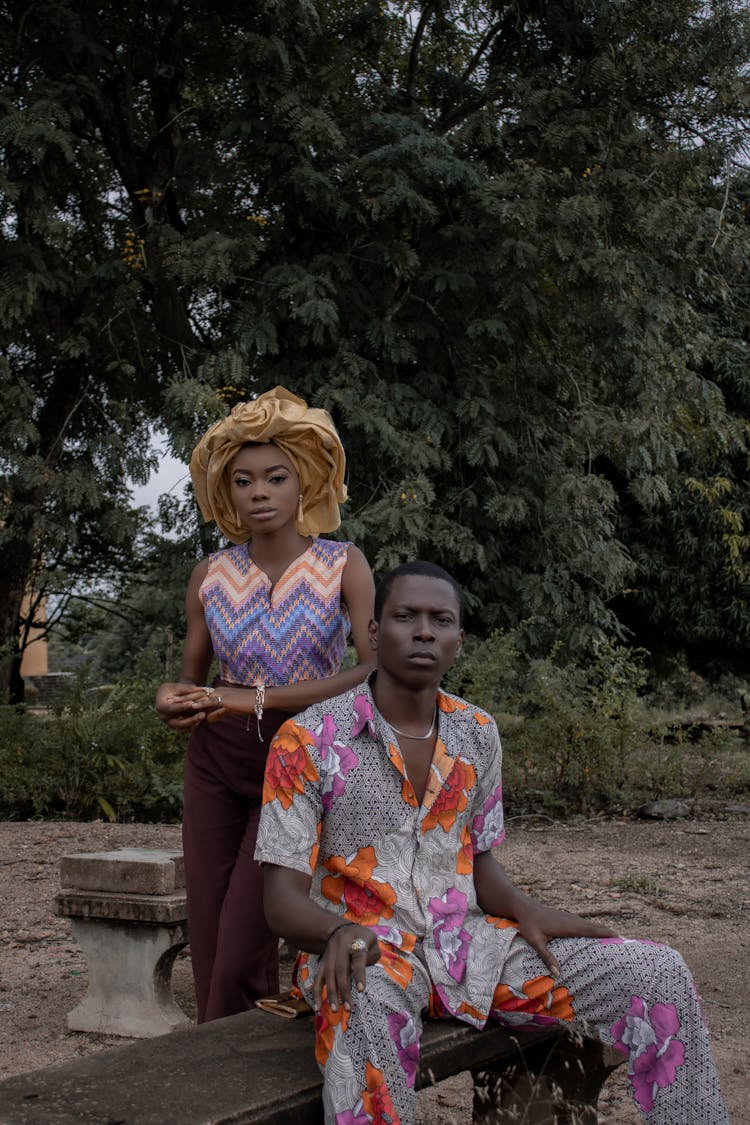 Black Couple In Nature Near Tree Looking At Camera