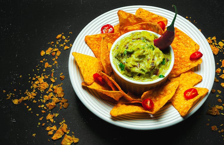 Plate With Crispy Nachos And Savory Guacamole