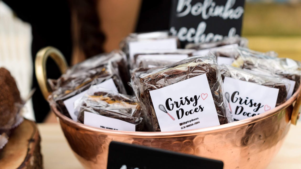 Free Sweets in cellophane bags heaped in bowls for selling Stock Photo