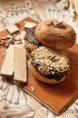 Chocolate donuts with waffles on wooden board