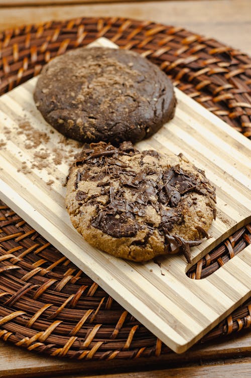 Fresh chocolate cookies on wooden board