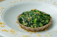 Delicious salad in crispy tartlet served on plate