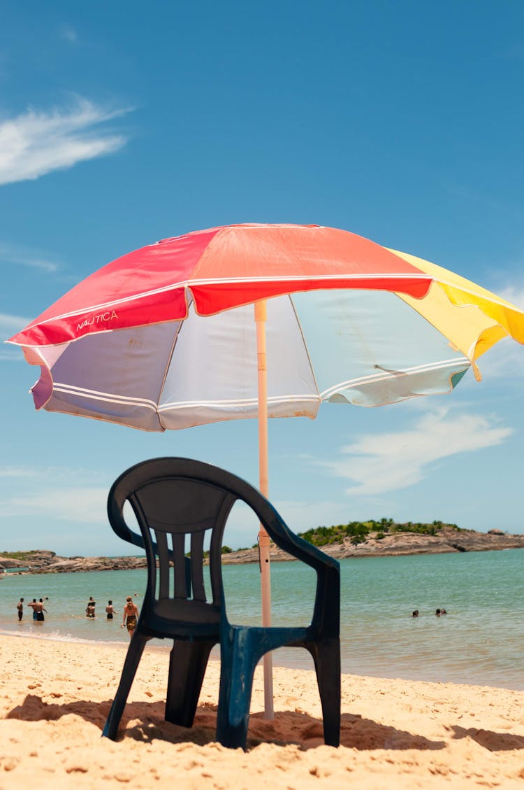 Umbrella Over Chair On Beach