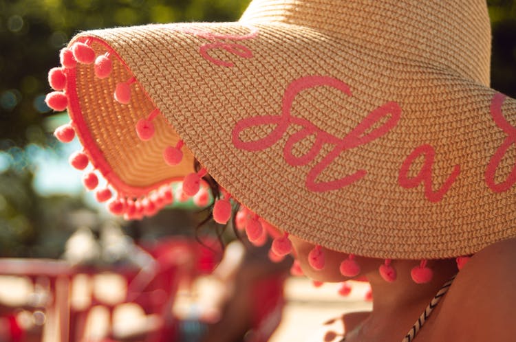 Faceless Woman In Straw Hat On Beach