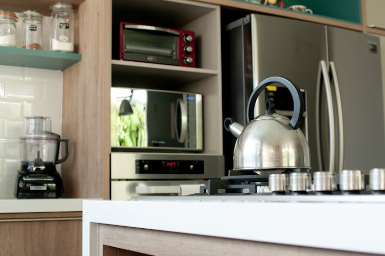 Metal Kettle On Stove In Modern Kitchen