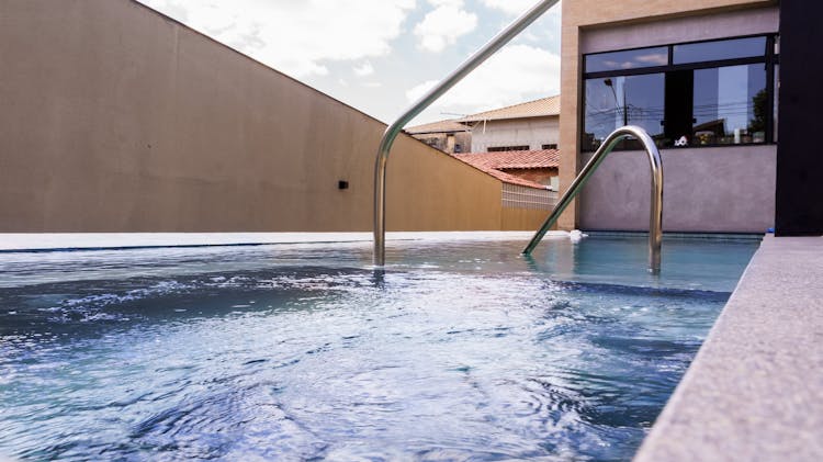 Grab Bars Ladder In Modern Swimming Pool Of House