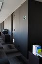 Contemporary workspace interior with ornamental floor and wooden door with exit sticker near books