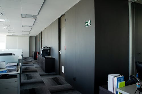 Modern workplace interior with tables and carpeting floor