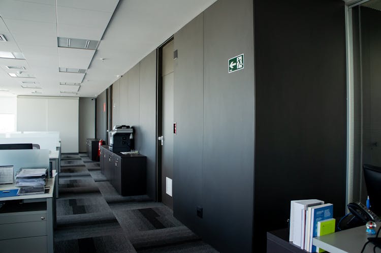 Modern Workplace Interior With Tables And Carpeting Floor