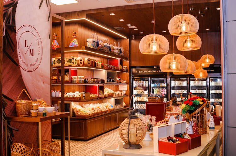 Modern Shop Of Sweets In Gift Boxes Under Glowing Lamps