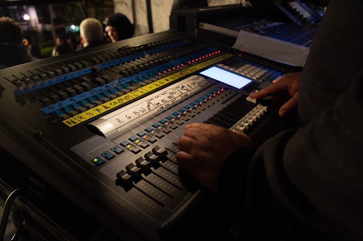 Crop Faceless Audio Engineer Working On Soundboard Console During Concert