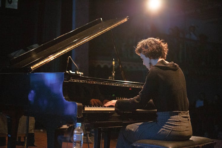 Female Pianist Playing Piano On Stage During Concert