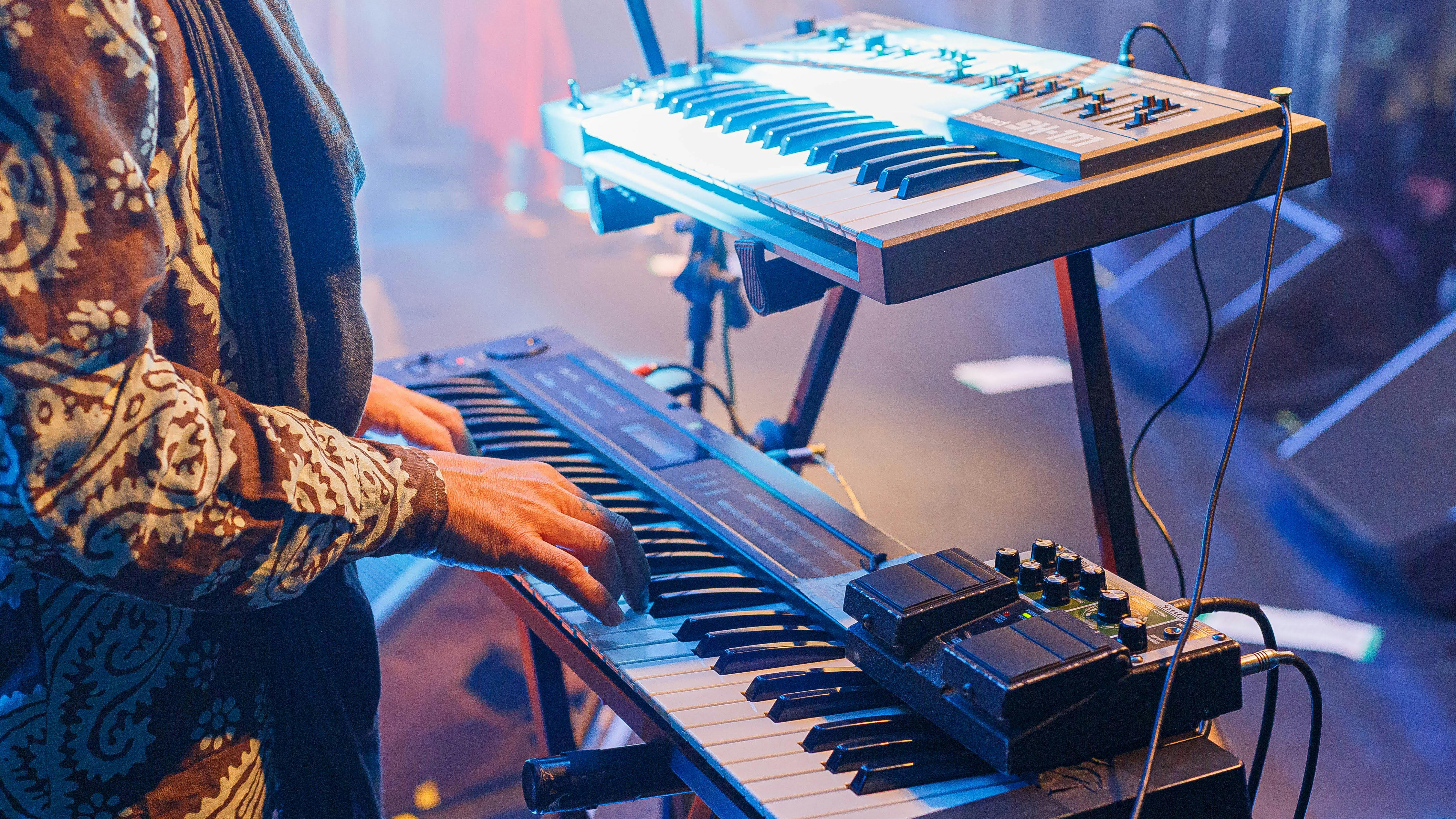 crop unrecognizable musician playing synthesizer at concert