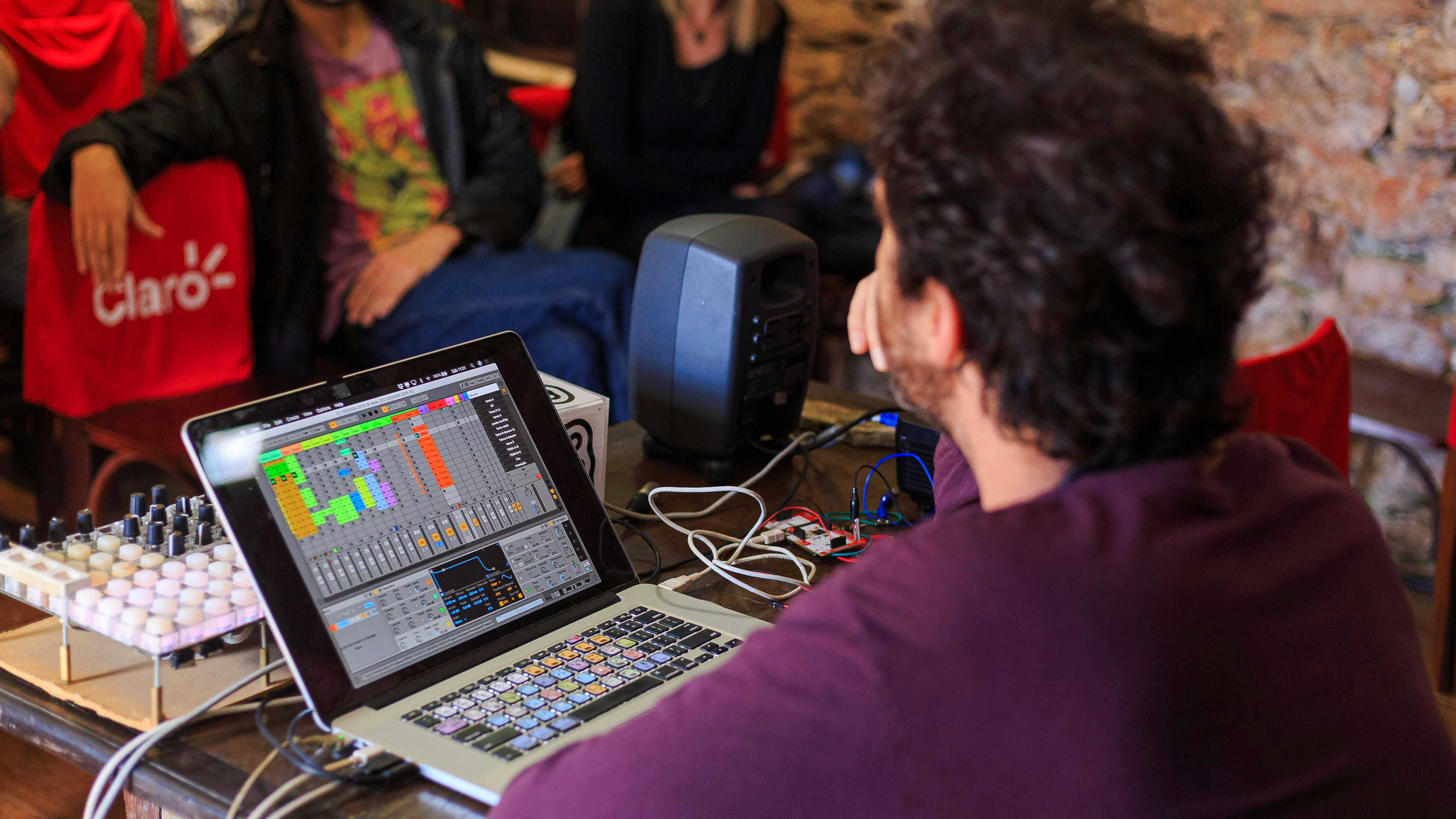 unrecognizable sound director sitting at table with laptop and mixer