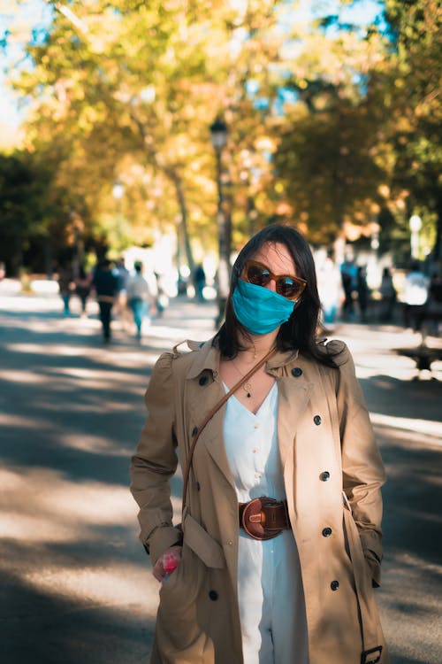 A Woman in Brown Coat Wearing a Face Mask