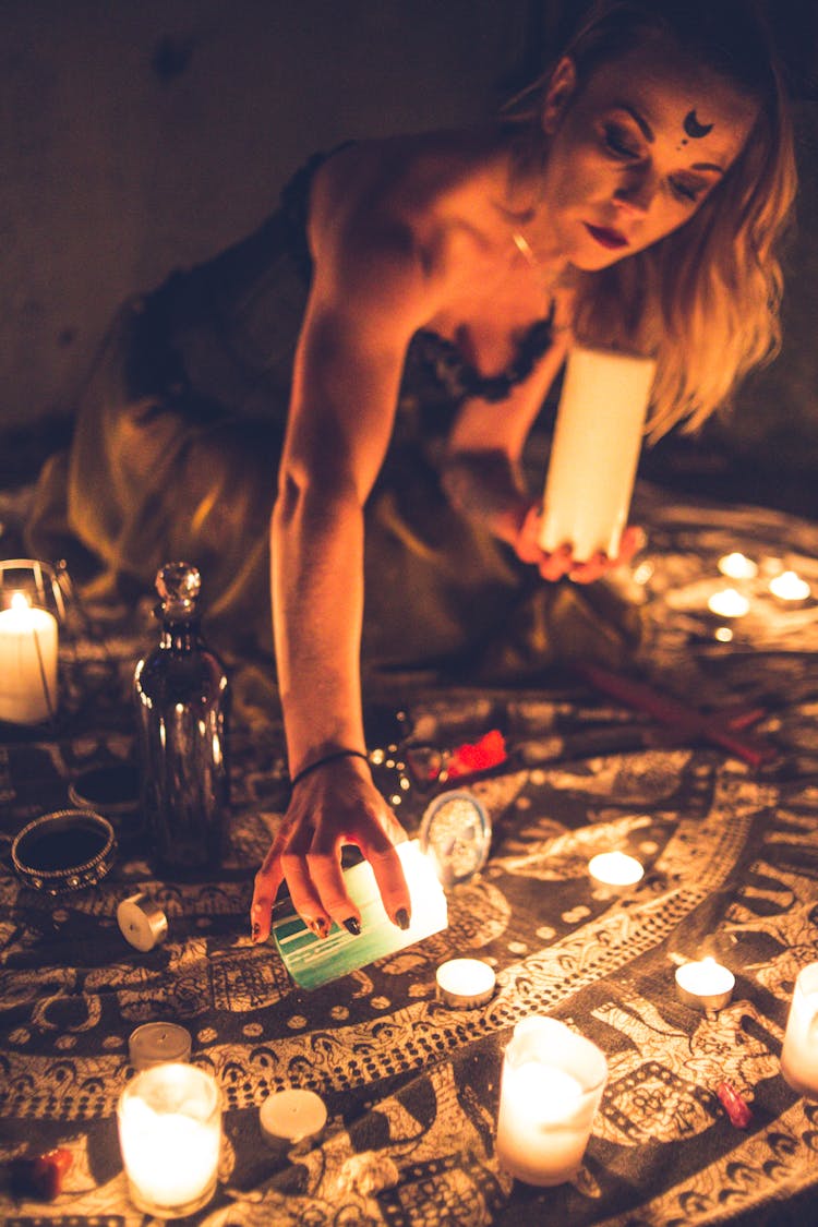 Woman Burning Candles On Carpet For Worship