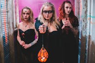 Dark witches with lamp and cross