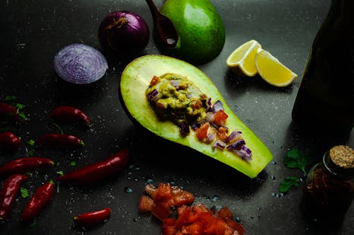 Free Half of fresh avocado under guacamole Stock Photo