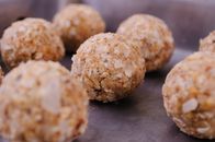 Uncooked round meatballs on metal tray
