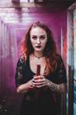 Redhead witch with cross in smoke