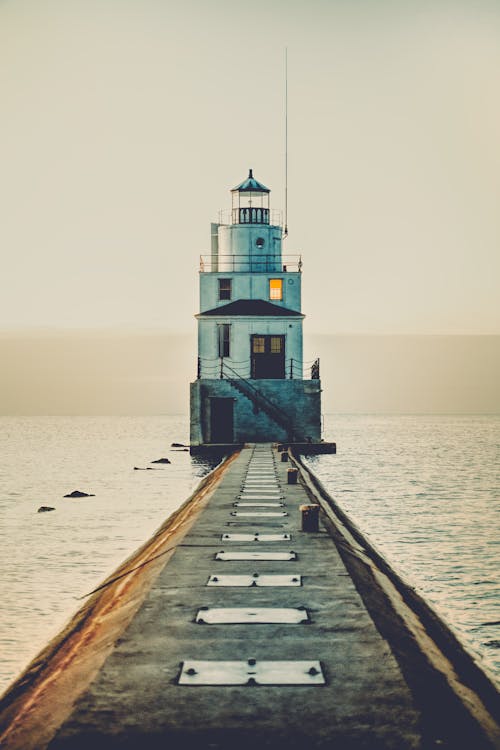 White Light House Near Body of Water