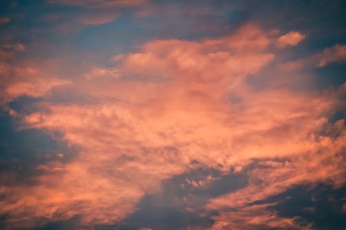 Free Evening sky with floating orange clouds Stock Photo