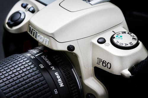 Close-Up Shot of White Nikon DSLR Camera