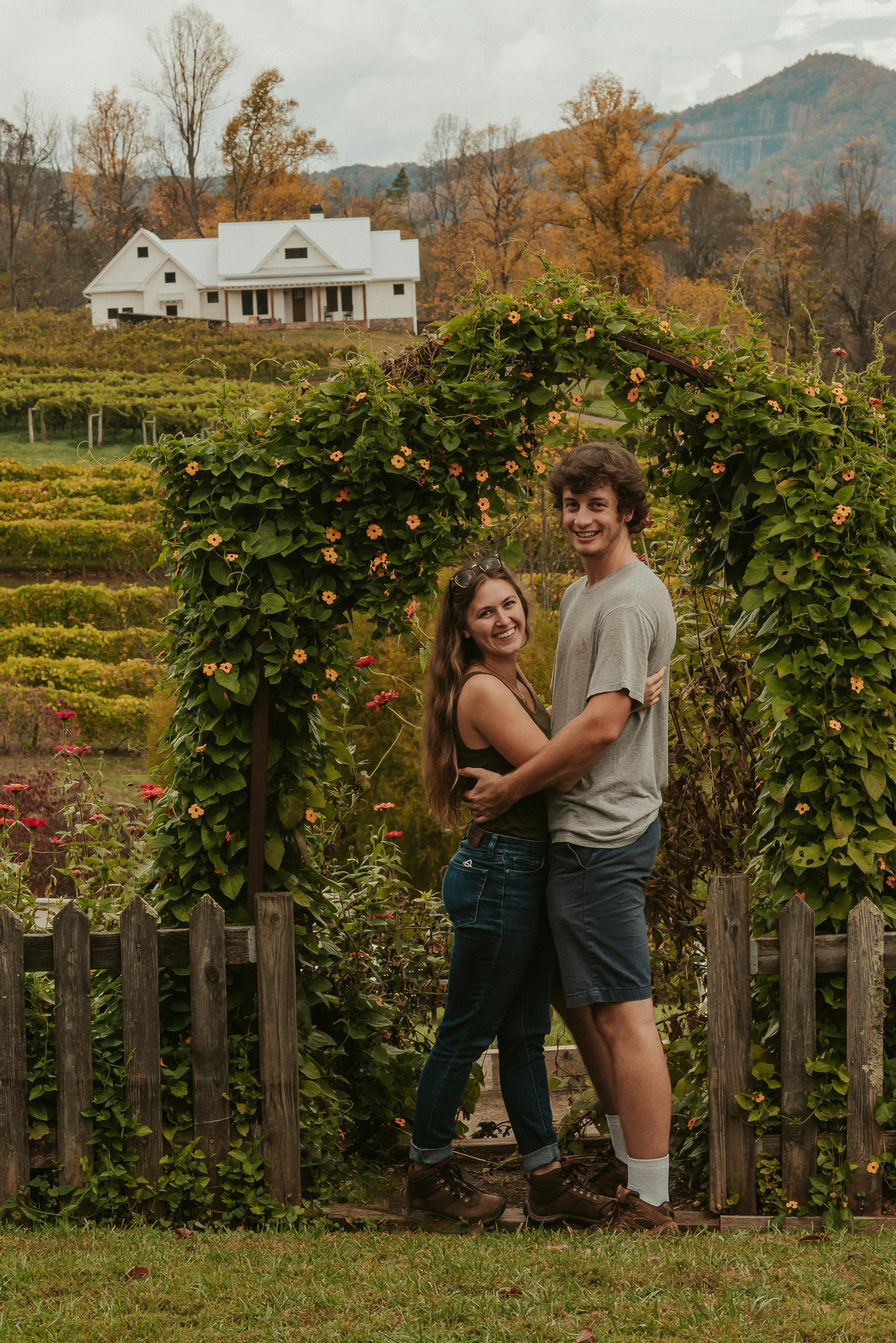 Cheerful young couple embracing in countryside · Free Stock Photo