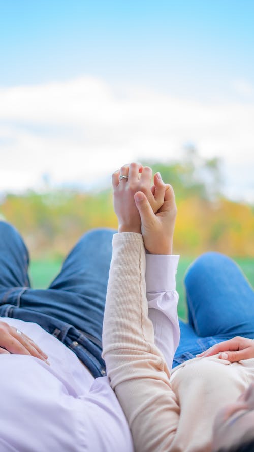 Free Close-Up Shot of a Couple Holding Hands Stock Photo