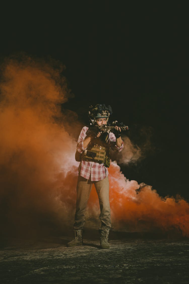 Man With Paintball Gun Shooting In Smoke