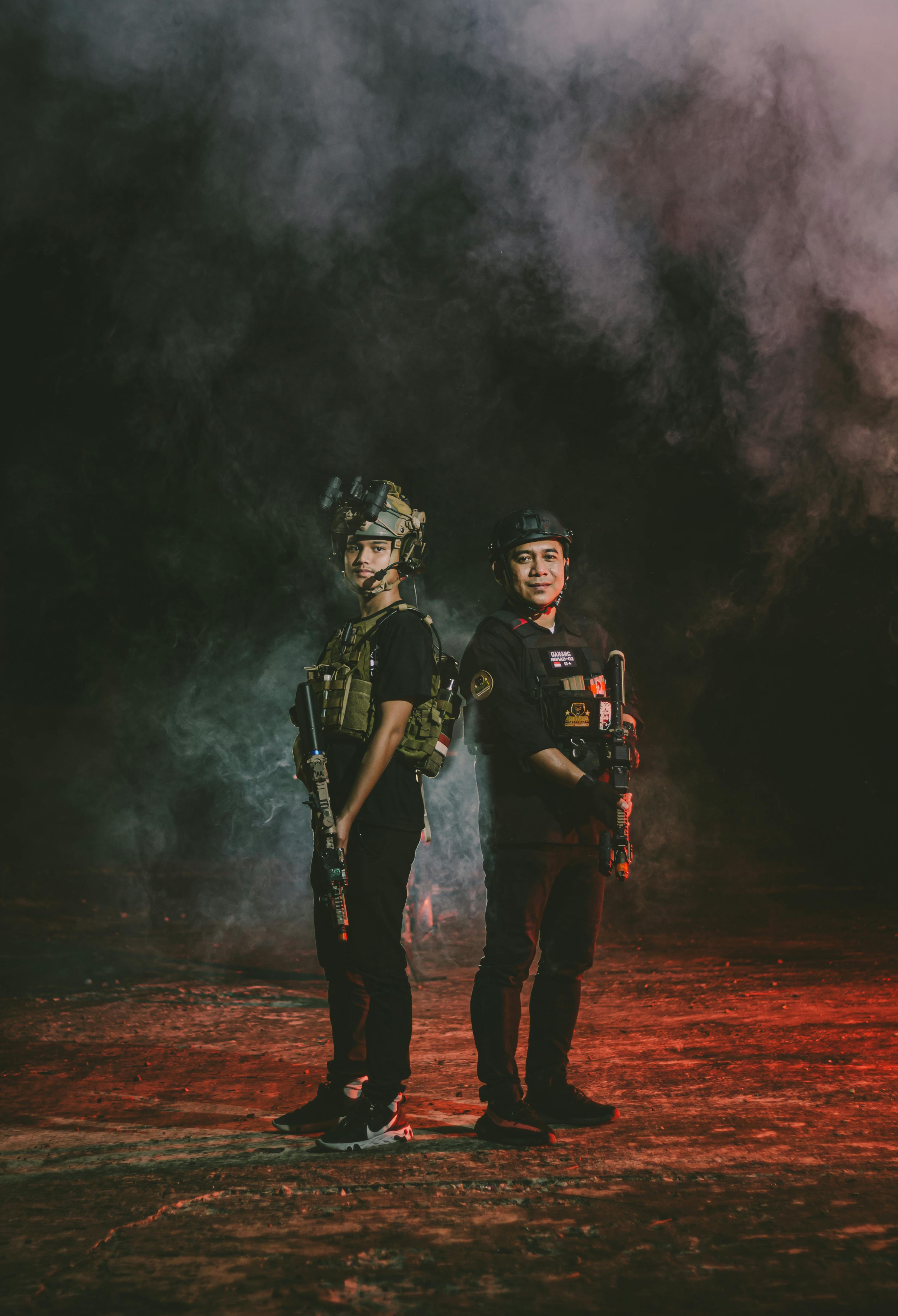 men in military gear standing in cloud of smoke