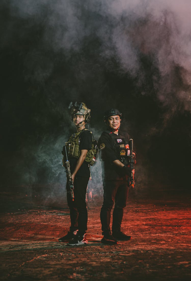 Men In Military Gear Standing In Cloud Of Smoke