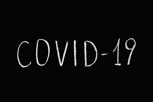 White chalked 'COVID-19' text on a blackboard background, emphasizing pandemic theme.