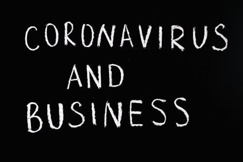 Free Coronavirus and Business Lettering Text on Black Background Stock Photo