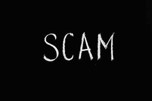 Free Scam Lettering Text on Black Background Stock Photo