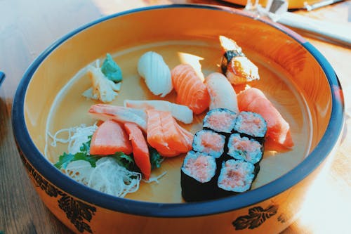 Delicious assorted sushi and rolls in bowl