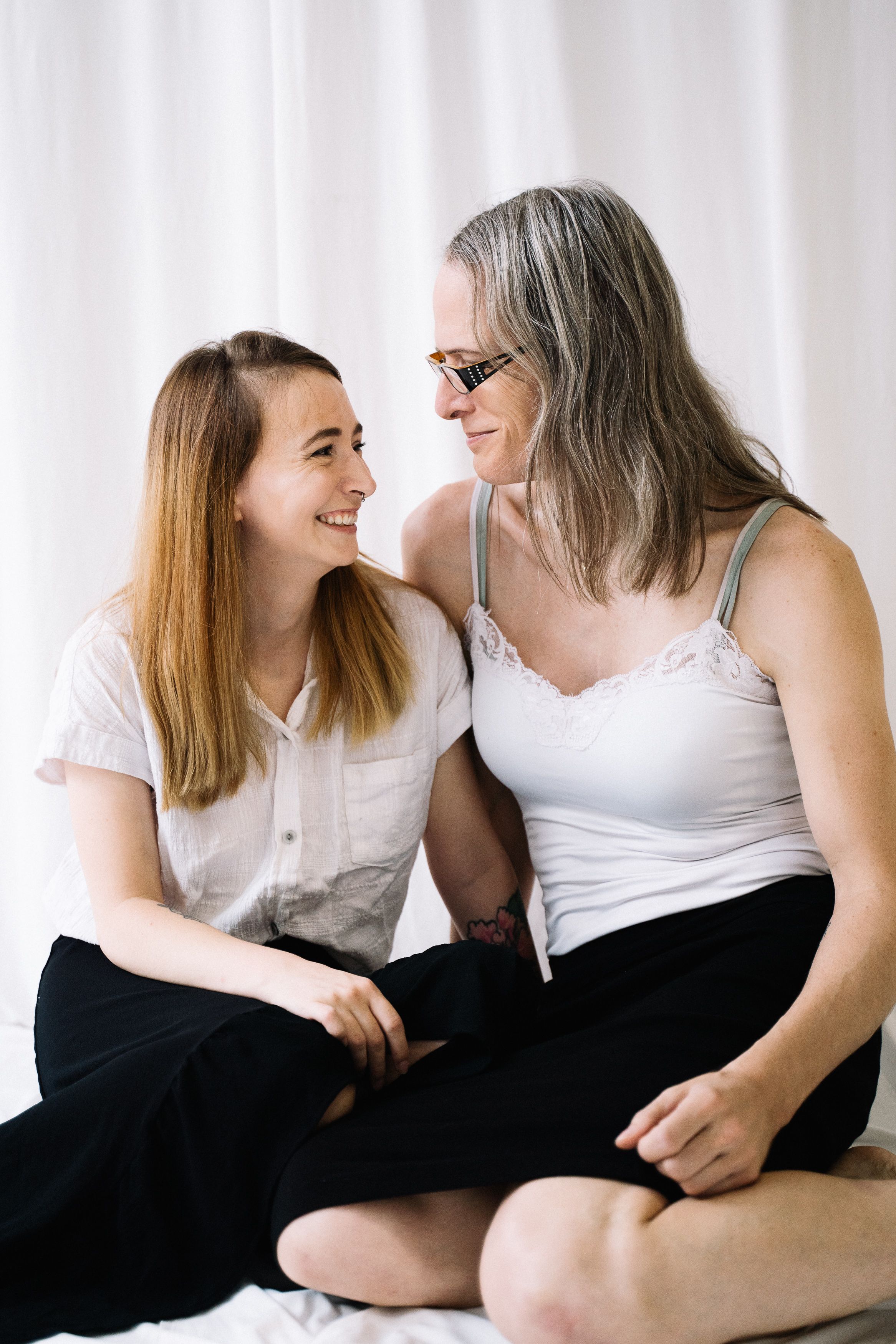 A tender moment between a smiling couple, showcasing love and togetherness indoors.