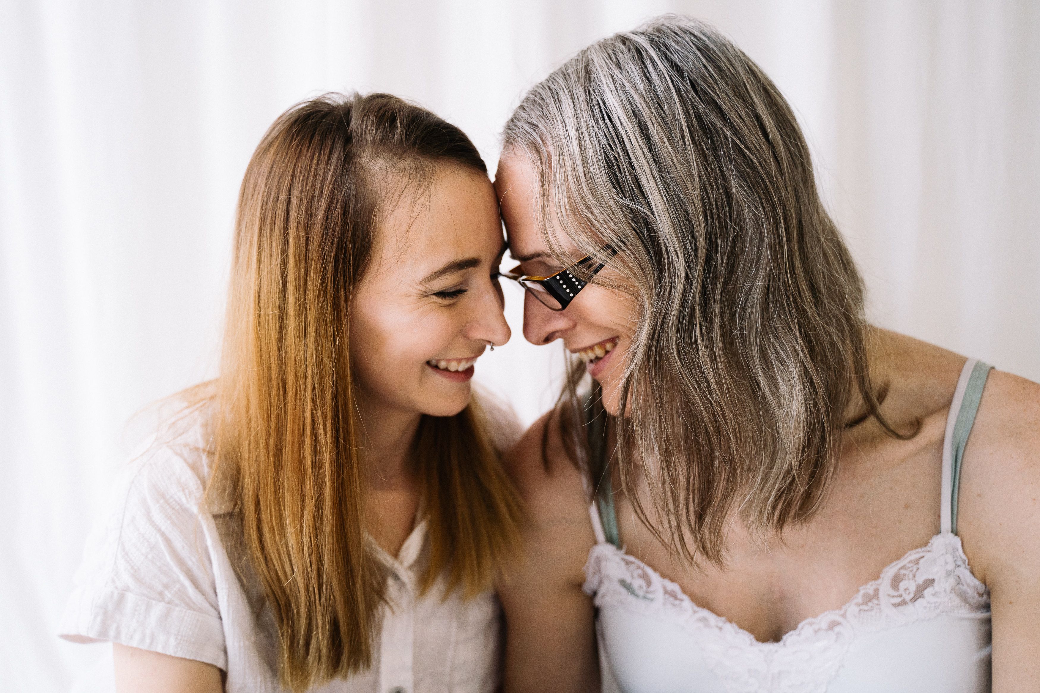 Two women sharing a heartfelt moment, expressing love and happiness in a warm embrace.