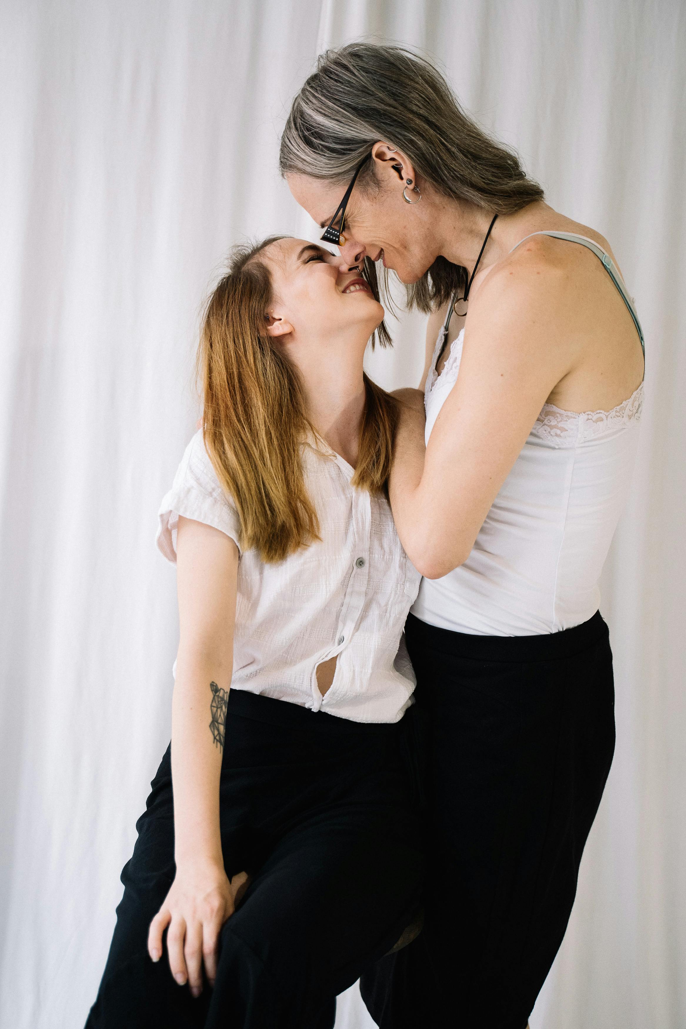 Lesbian Couple Smiling and Almost Kissing · Free Stock Photo