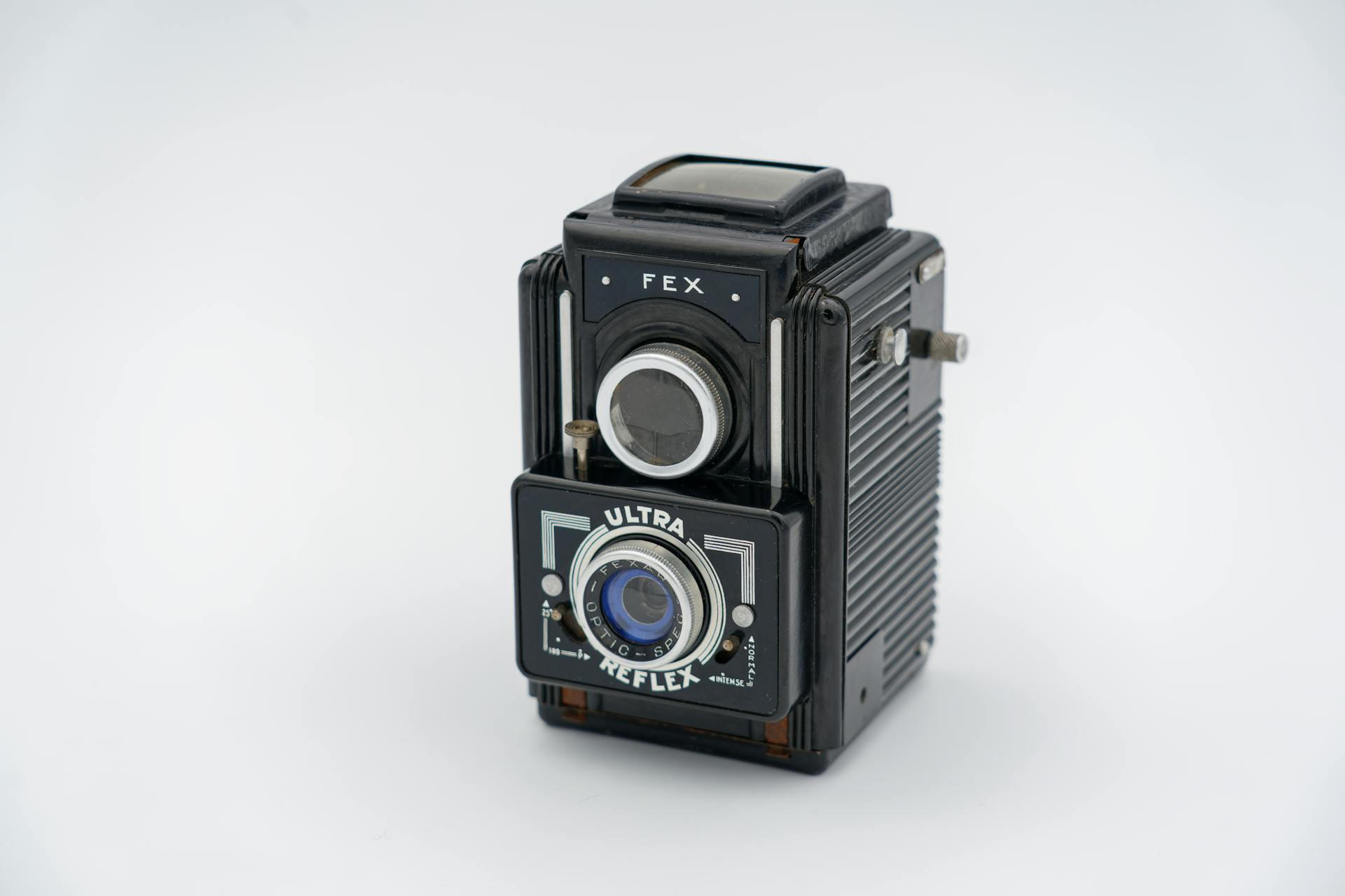 Close-up shot of a retro FEX Ultra Reflex camera on a white background, showcasing vintage design.