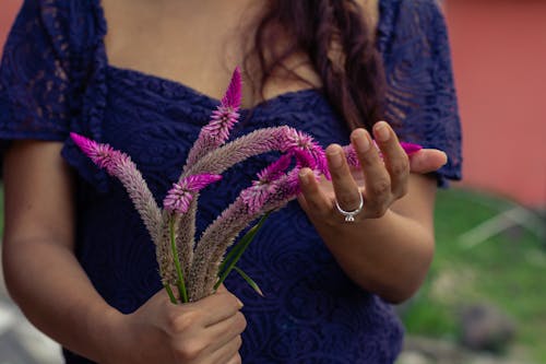 Woman Holding Purple Flowers